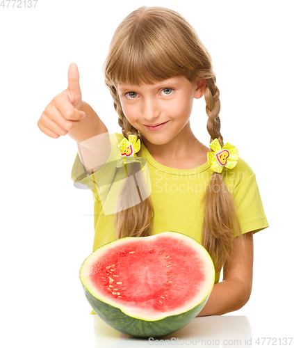 Image of Little girl is eating watermelon