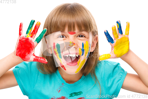 Image of Portrait of a cute girl playing with paints