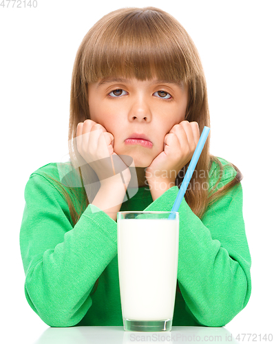 Image of Gloomy little girl doesn\'t want to drink milk