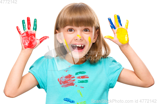 Image of Portrait of a cute girl playing with paints