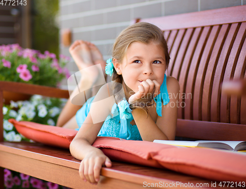 Image of Little girl is reading a book