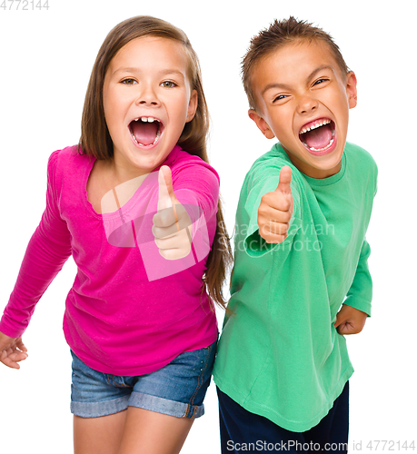 Image of Little boy and girl are showing thumb up sign