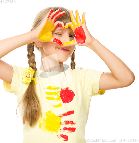 Image of Portrait of a cute girl playing with paints