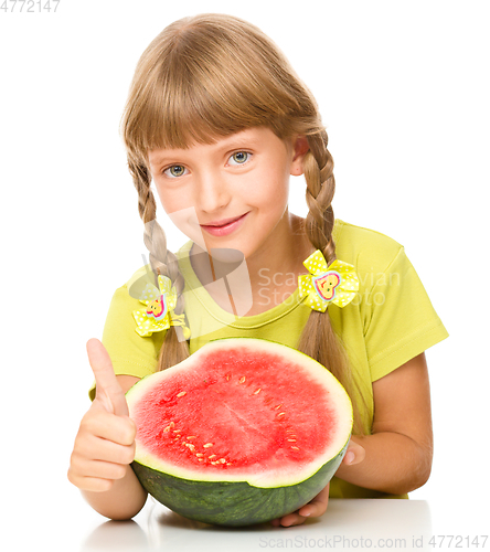Image of Little girl is eating watermelon