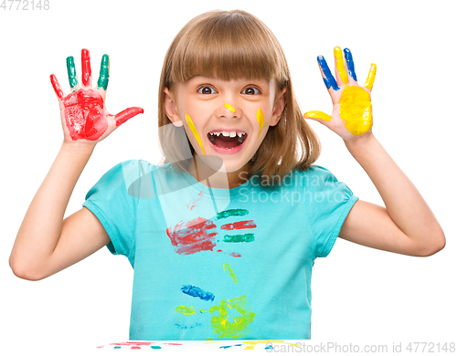 Image of Portrait of a cute girl playing with paints