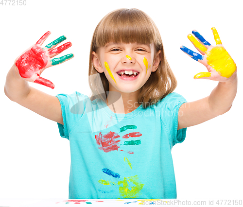 Image of Portrait of a cute girl playing with paints