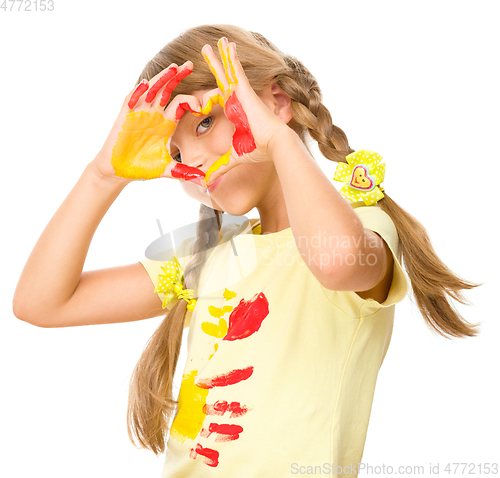 Image of Portrait of a cute girl playing with paints