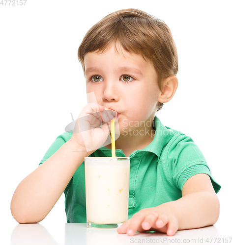 Image of Cute little boy with a glass of milk