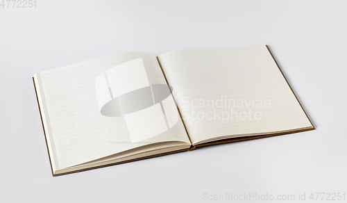 Image of Open blank notebook isolated on grey