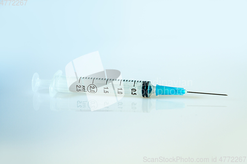 Image of Syringe on blue background