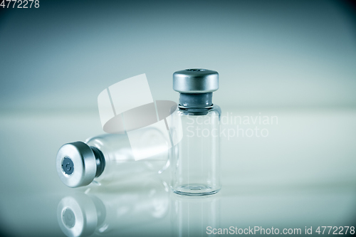 Image of two vaccine bottles on grey background