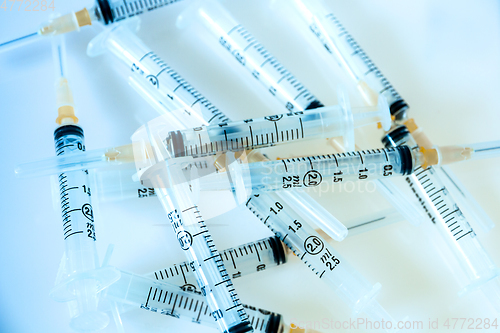 Image of Syringes on blue background