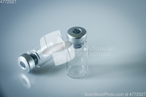 Image of two vaccine bottles on grey background