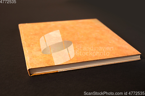 Image of Closed blank notebook isolated on black