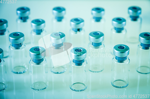 Image of Vaccine glass bottles on blue background