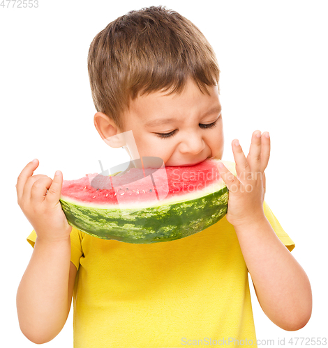 Image of Little boy is eating watermelon
