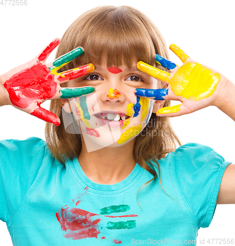 Image of Portrait of a cute girl playing with paints