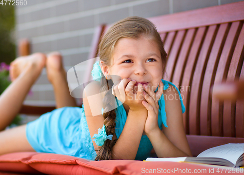 Image of Little girl is reading a book