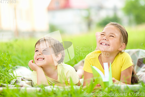Image of Little girl and boy are playing outdoors