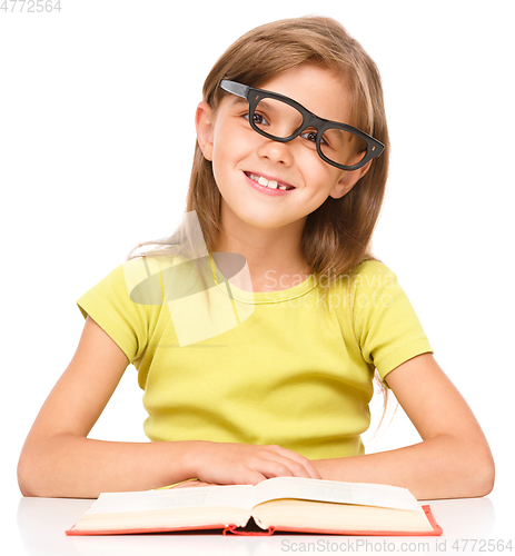 Image of Little girl is reading a book