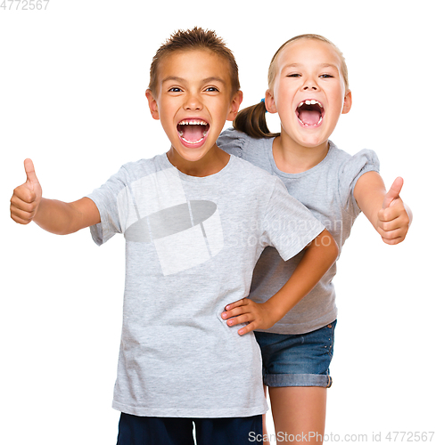 Image of Little boy and girl are showing thumb up sign