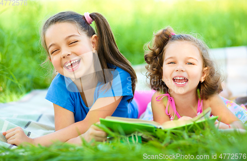 Image of Two little girls are reading book