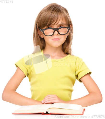 Image of Little girl is reading a book