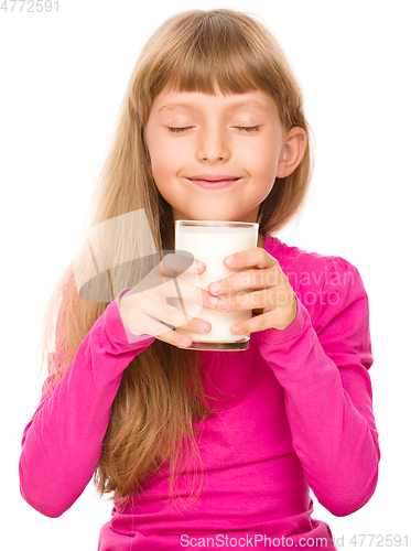 Image of Happy little girl with a glass of milk