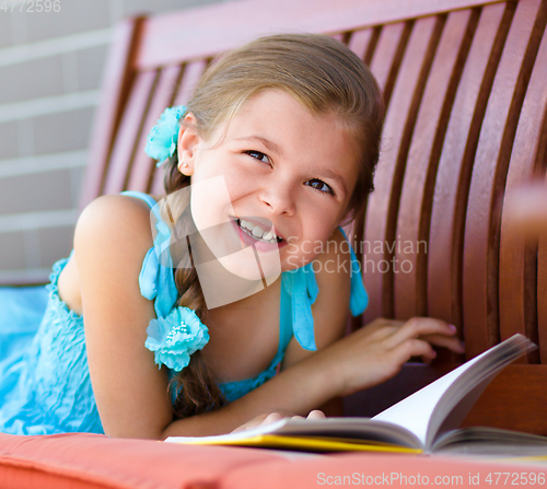 Image of Little girl is reading a book