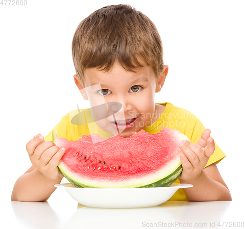 Image of Little boy is eating watermelon