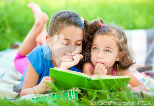 Image of Two little girls are reading book