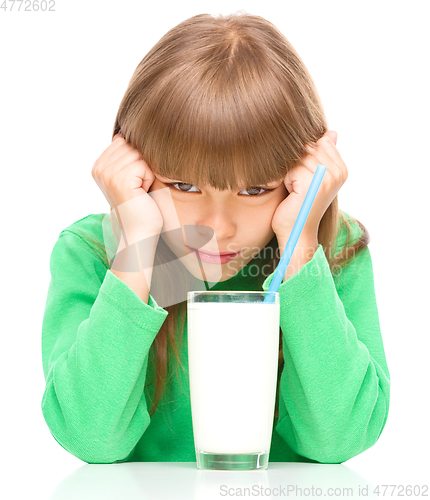Image of Gloomy little girl doesn\'t want to drink milk