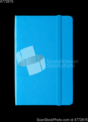 Image of Cyan blue closed notebook isolated on black