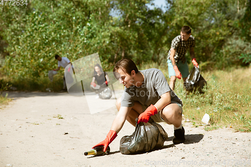 Image of Group of volunteers tidying up rubbish on beach