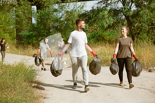 Image of Group of volunteers tidying up rubbish on beach