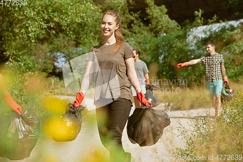 Image of Group of volunteers tidying up rubbish on beach