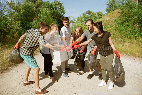 Image of Group of volunteers tidying up rubbish on beach