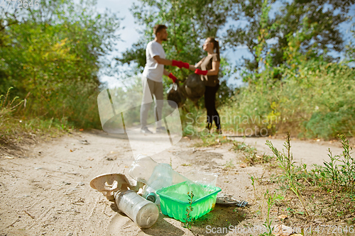 Image of Group of volunteers tidying up rubbish on beach