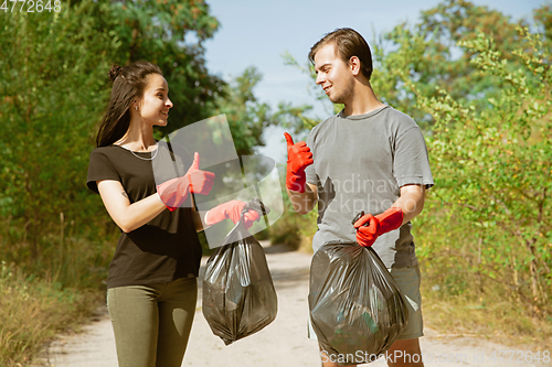 Image of Group of volunteers tidying up rubbish on beach