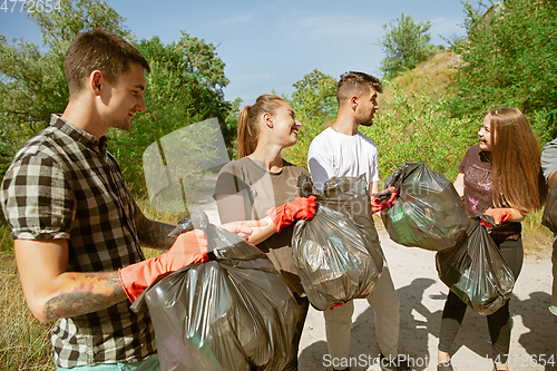 Image of Group of volunteers tidying up rubbish on beach