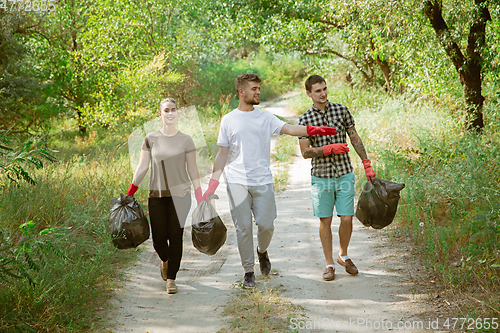 Image of Group of volunteers tidying up rubbish on beach