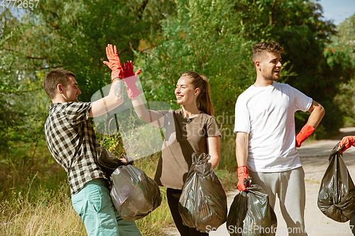 Image of Group of volunteers tidying up rubbish on beach