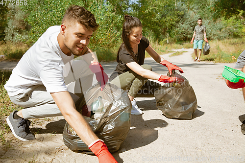 Image of Group of volunteers tidying up rubbish on beach