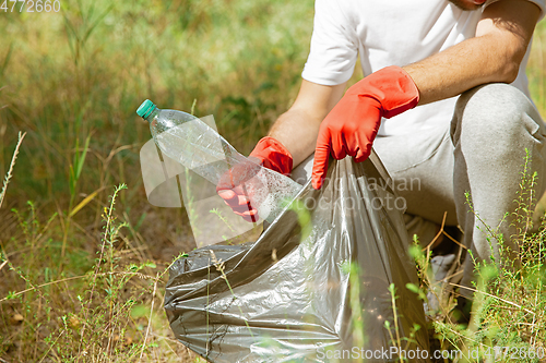 Image of Volunteer tidying up rubbish on beach