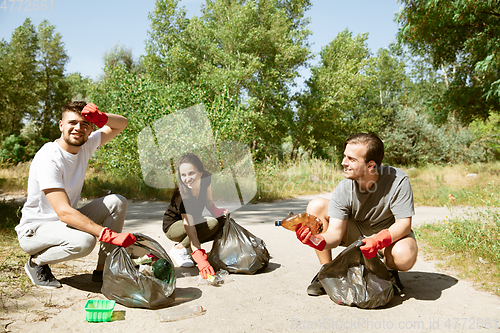 Image of Group of volunteers tidying up rubbish on beach