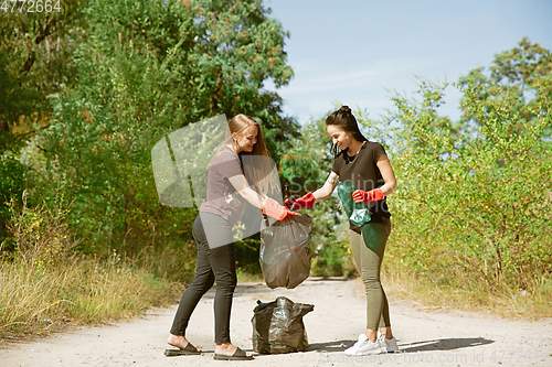 Image of Group of volunteers tidying up rubbish on beach