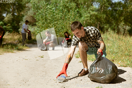 Image of Group of volunteers tidying up rubbish on beach