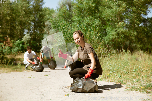 Image of Group of volunteers tidying up rubbish on beach