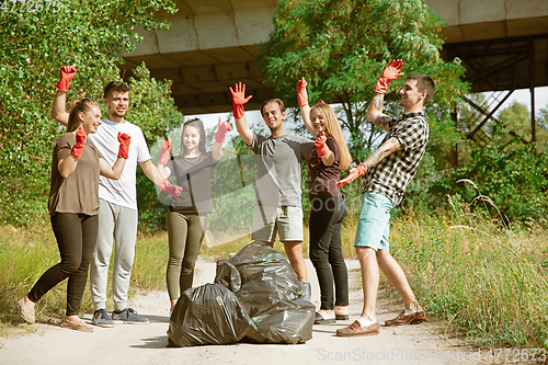 Image of Group of volunteers tidying up rubbish on beach