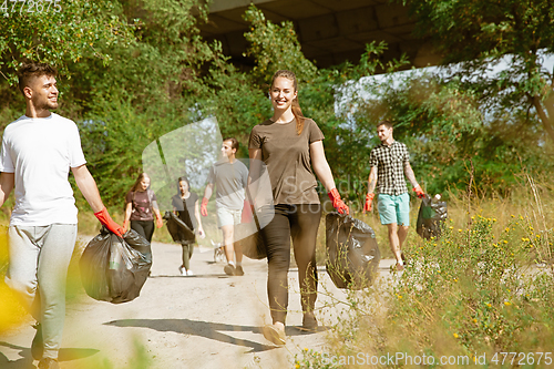 Image of Group of volunteers tidying up rubbish on beach